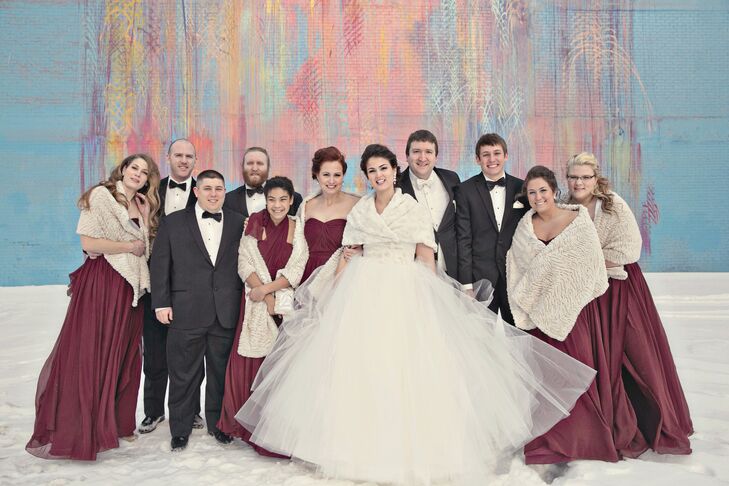 Emily and her attendants accessorized their gowns with ivory wraps to ward off the winter chill. The groom and groomsmen kept it classic in traditional black tuxedos.