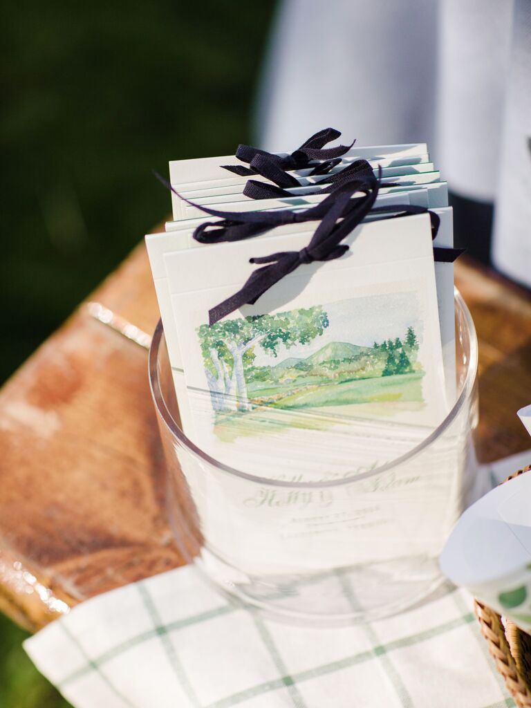 watercolor ceremony programs tied with navy blue grosgrain ribbon bows