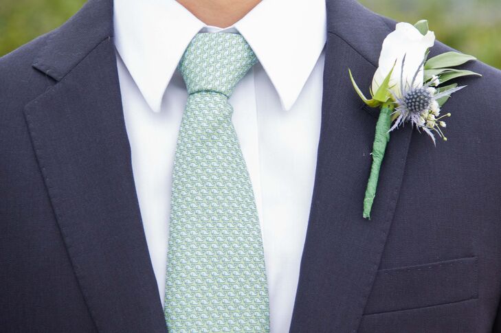 Brennan and his groomsmen added white rose and blue thistle boutonnieres to their navy suit jackets for a polished finish.