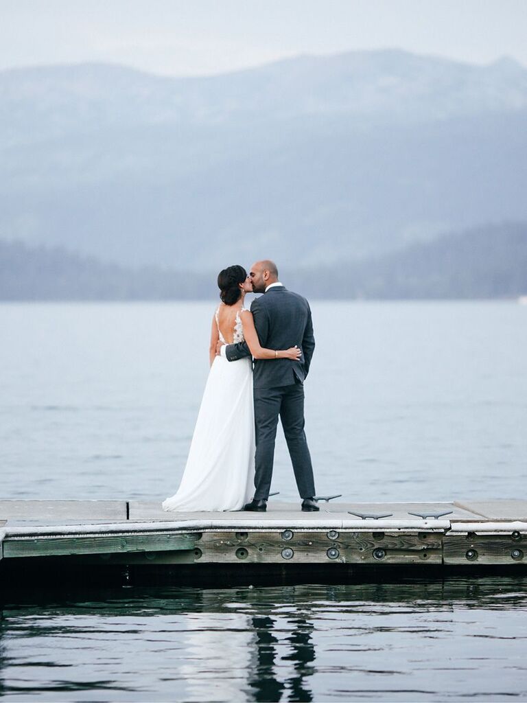 bride and groom kissing on a dock Idaho