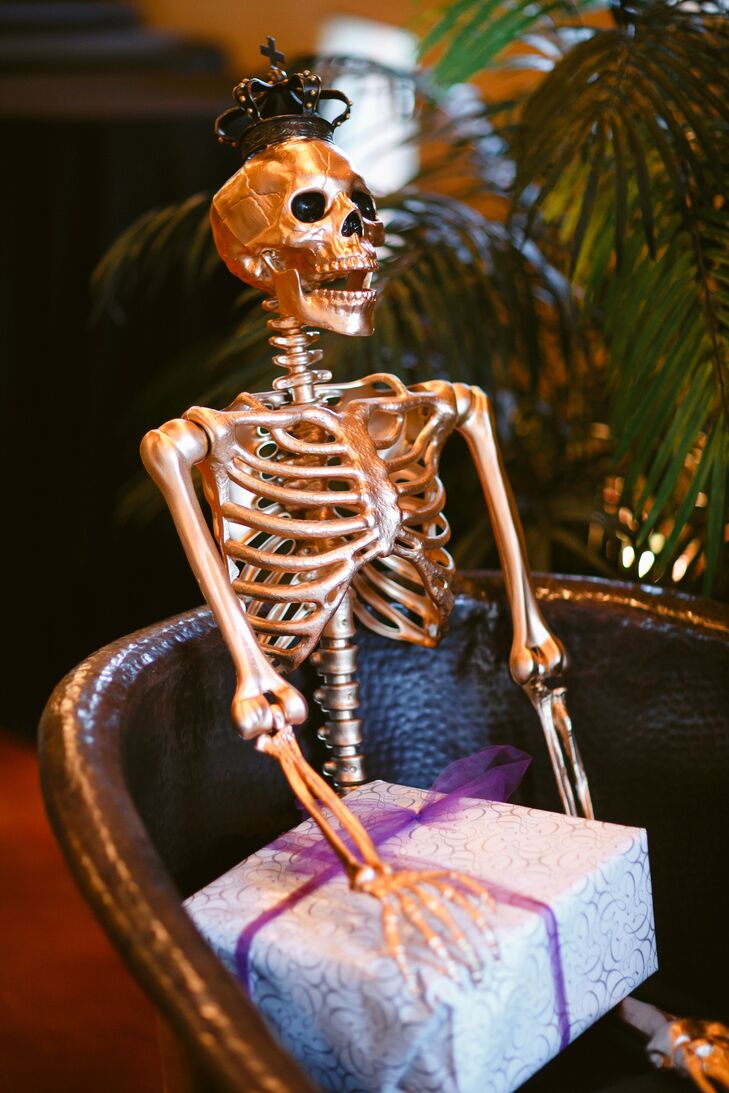 The bride painted a skeleton in gold leaf for the Halloween themed reception party. Though Halloween parties are traditionally spooky and dark, she chose to go with bright colors for a classy, elegant atmosphere.
