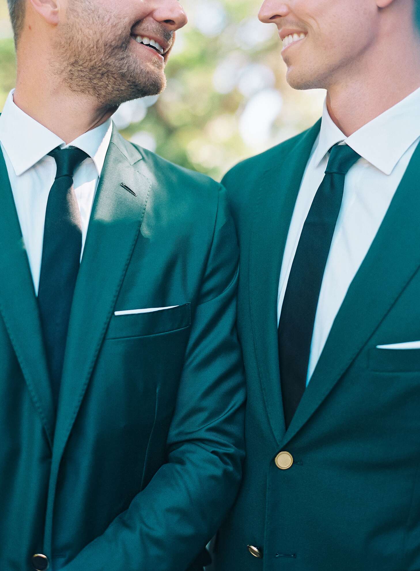 Grooms in Chic, Matching Emerald Green Suits With Gold Buttons