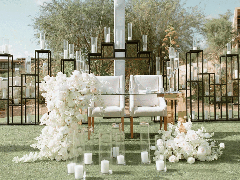 Glamorous sweetheart table at an outdoor wedding reception.