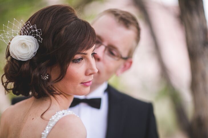 Miri wore a white fabric floral fascinator with pearl accents to complement her elegant bridal fashion.