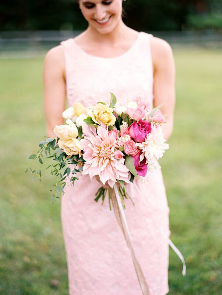 The bridesmaids' bouquets had a similar romantic, whimsical feel to Kristina's and were filled with full blooms like dahlias, roses and ranunculuses in shades of pink, peach, ivory and cream.