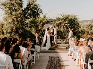 Natalie and Ryan's wedding at Tin Roof Barn in White Salmon, Washington, embodied the coziness of home with its boho-chic reception decor and beige-an