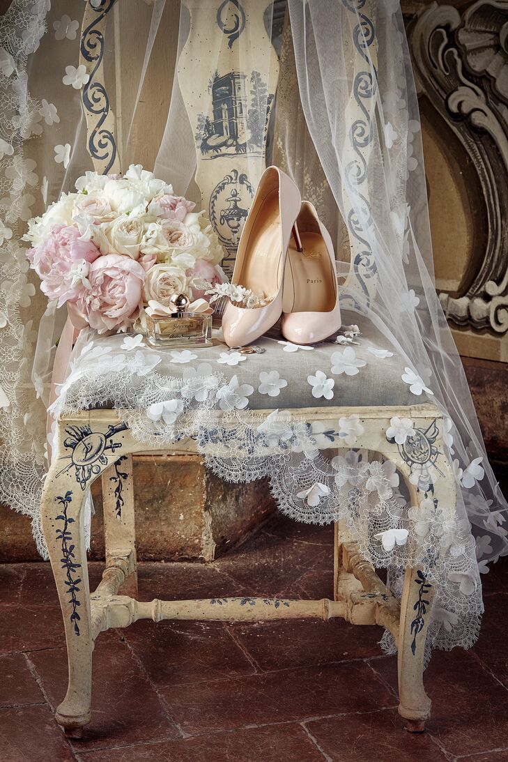 Nina wore Christian Louboutin pumps in the color ballerina and a long custom veil—with hand-stitched flowers and delicate lace—from Lerina.