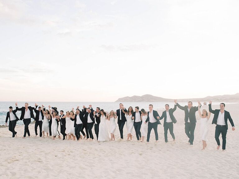 wedding party walking on there beach