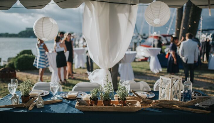 The ceiling of the tent was decorated with striped lanterns and stringed globe lights. Tiki torches were placed around the tent and near the bar area.