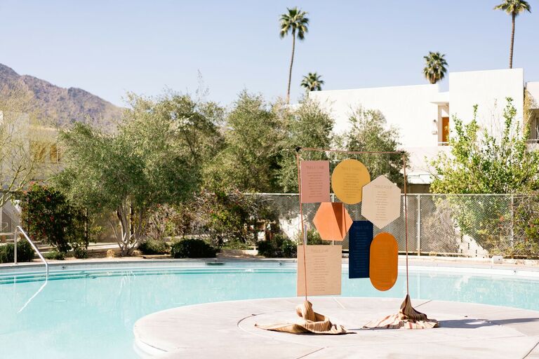 Colorful geometric seating chart at poolside Palm Springs wedding