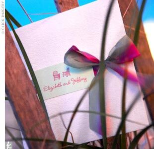 “The invitations elicited a great response from our families, who all agreed they were the most beautiful they had ever seen,” Elizabeth says. The invites were a tri-fold style, with the outside made from heavy, natural, sand-colored card stock, and tied off with a pink and green silk ribbon. A green paper seal printed with pink ink adorned the front, with the couple’s names and an illustration of two Adirondack chairs to set the tone for their beach wedding.
