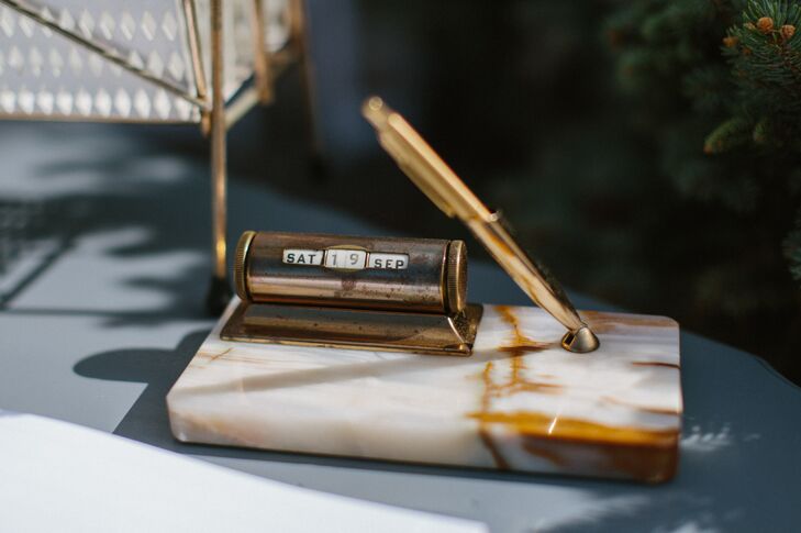 Guests were invited to sign the guest book with a vintage calendar pen, a throwback detail the couple included throughout the ceremony.