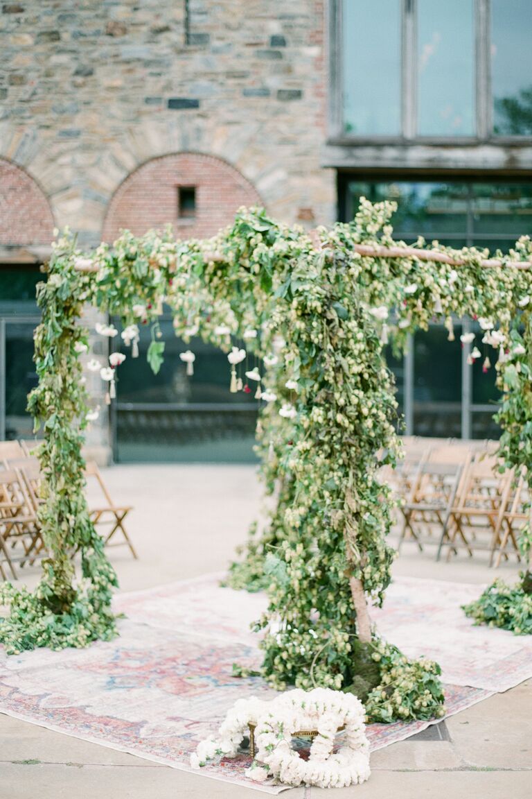 Green mandap covered in hops garland