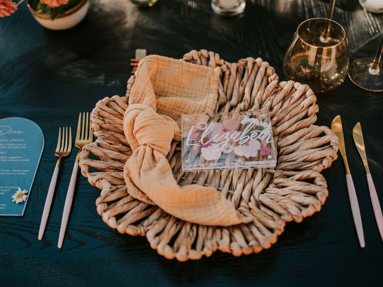 Boho rattan charger at wedding reception table