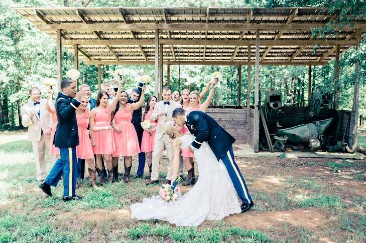 Samantha and Chris's wedding party dressed in styles reflective of the bride and groom. Chris's groomsmen wore their formal military blues or a tan suit and navy bow tie. Samantha's bridesmaids brought out her feminine, Southern side in one-shoulder coral dresses and cowboy boots.