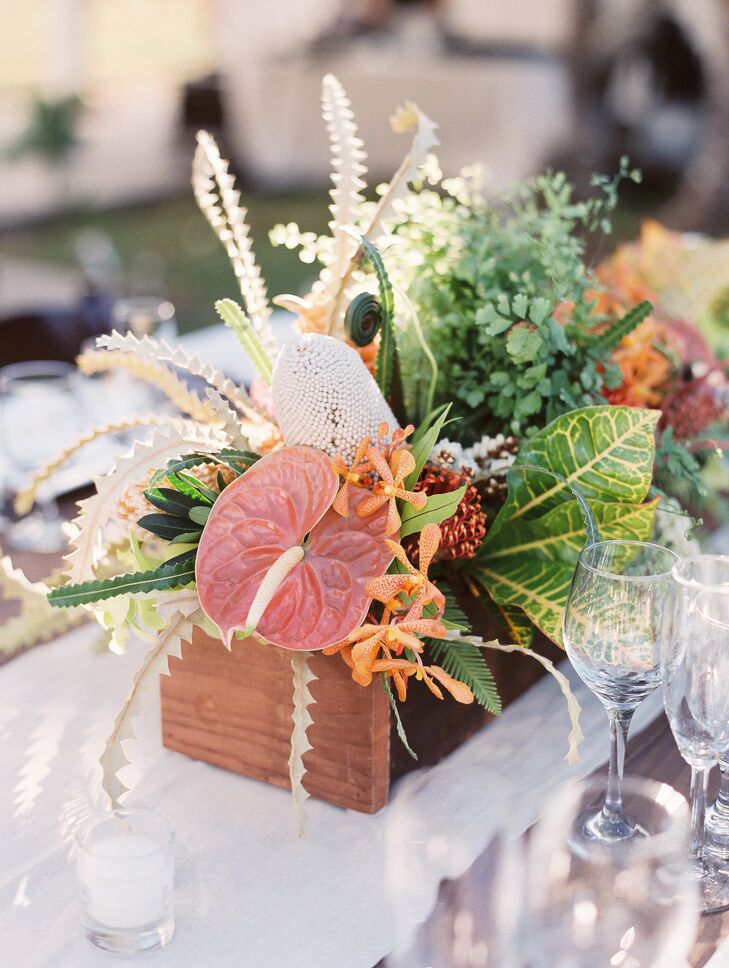 Lush tropical arrangements were created using orchids, ferns, tropical greens, proteas and even mini pineapples.