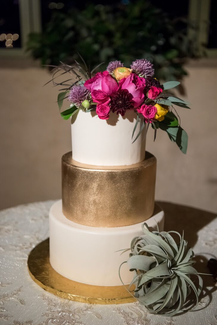 Las Vegas Custom Cakes crafted Jenna and Brett's three-tier dessert. "Our cake was ivory for the top and bottom tiers and had a gold middle tier. We only had  florals at the top, to match the florals throughout the wedding," Jenna says.