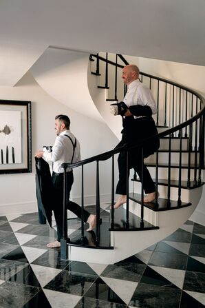 Grooms in Tuxes Walking Down Stairs While Getting Ready for Texas Wedding