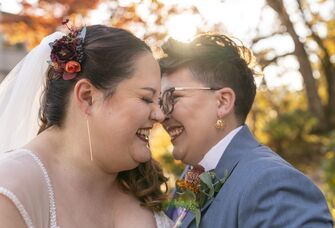 Couple laughs at a funny marriage quote. 