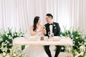 Couple Toasting Champagne at Sweetheart Table