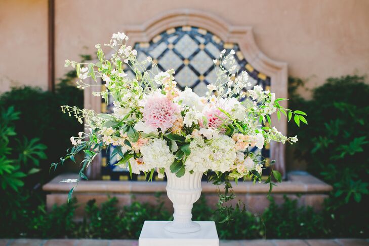 Two textured and romantic arrangements of dahlias, hydrangeas, stock and wildflowers greeted guests as they arrived to the ceremony and set the tone for the chic, romantic decor to come.
