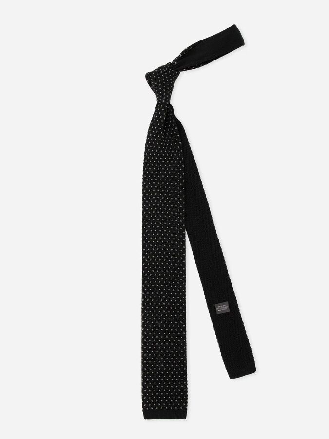 Casual black tie with a polka dot pattern. 