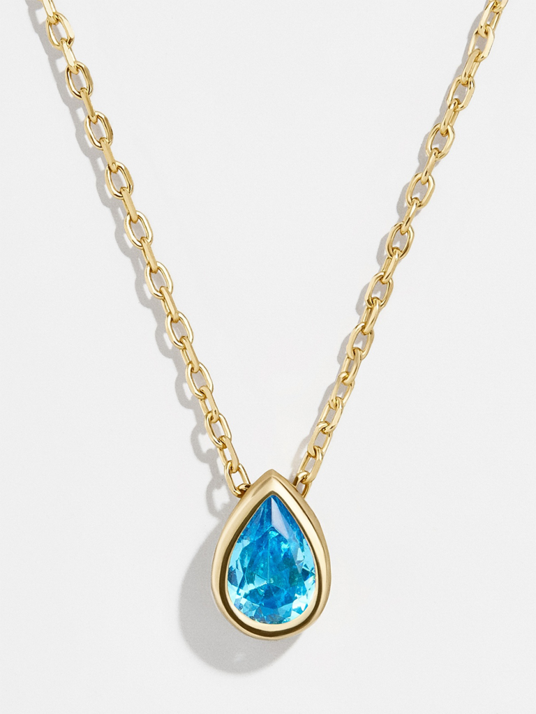 Blue CZ teardrop stone necklace set in gold on gold chain