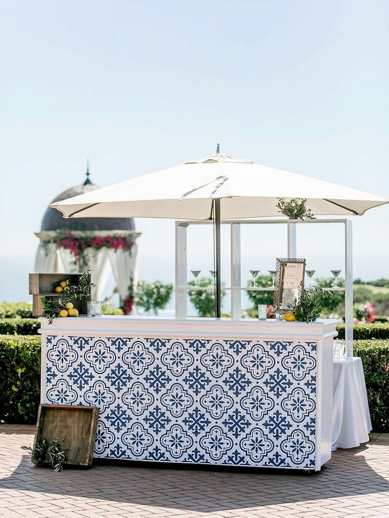 White and blue tile outdoor bar space with umbrella