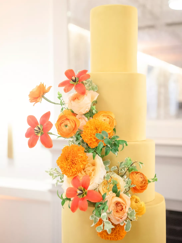 Pale yellow spring wedding cake with flowers