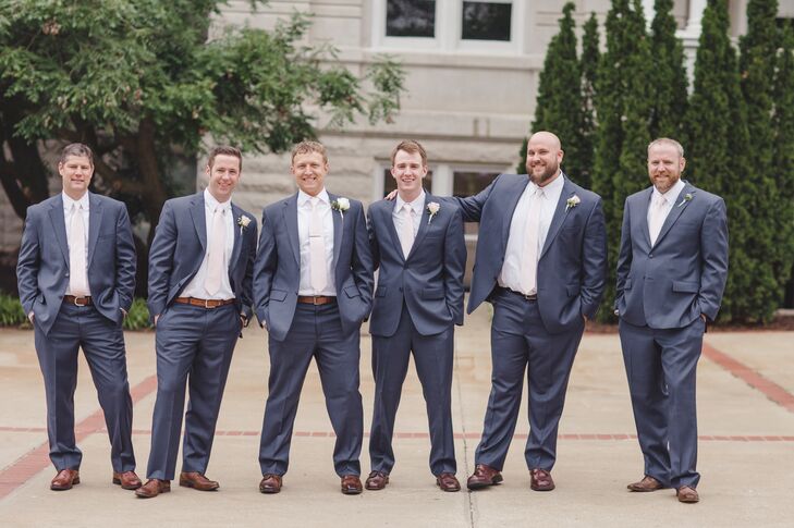 The groom and groomsmen wore postal blue suits.