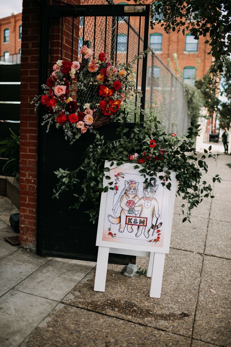Sandwich board sign with cat illustrations 
