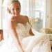 Kelly wore an ivory strapless wedding dress accented with lace and designed by Ines di Santo. She wore a traditional veil and Oscar de la Renta shoes.