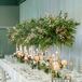 Tablescape With Candles and Tall Greenery Centerpiece