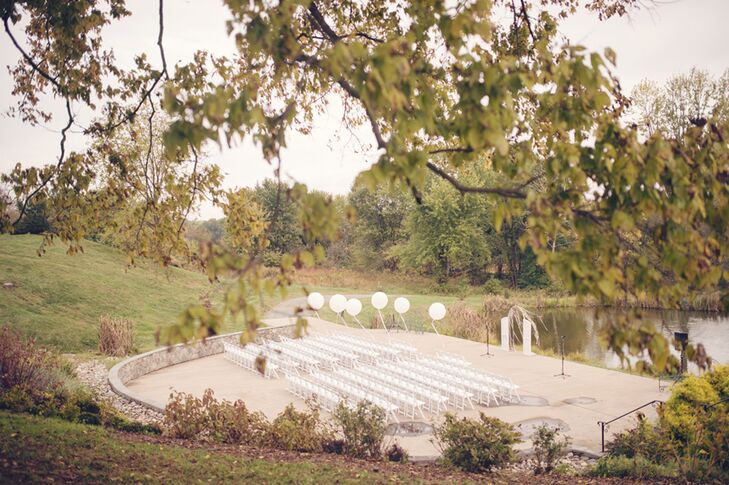 "We chose the location because it fit the number of people we were inviting  as well as had beautiful views of the Potomac, with rolling hills in the background and a barn that was just as beautiful on the inside as it was on the outside,” says Erin. For their waterfront ceremony, Dogwood Events helped to highlight the venue with rows of white folding chairs,  white balloons floating along the aisle and a white, shabby-chic white wedding arch.
