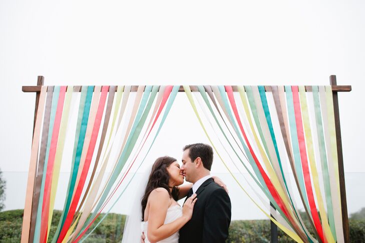 Bryan made the ceremony arch the couple wed under and Silvia added ribbons to it.
