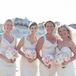 The bridesmaids donned these champagne cocktail dresses for Ryan and Brian's wedding. Ryan loved the clean, sheath-style fit and how they matched the classic blush, ivory and gold palette. The ladies completed their look with updos and crystal earrings.