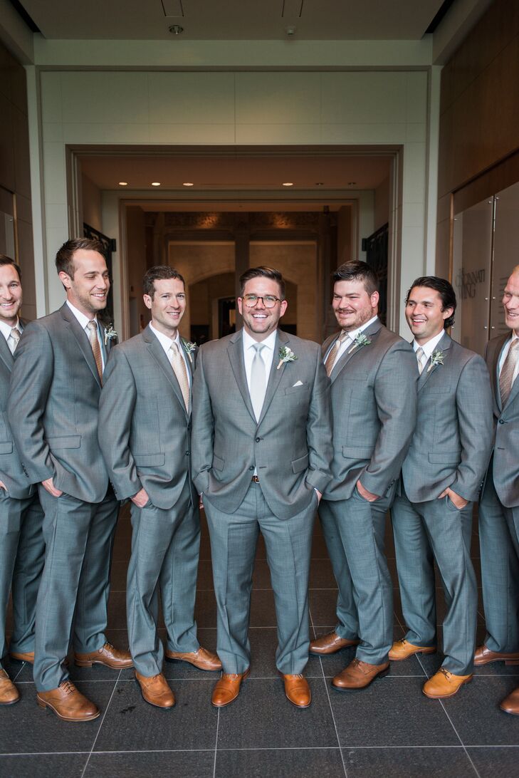 Alex wore a gray Calvin Klein suit with a solid gray tie (the groomsmen wore tan and white polka-dot ties). Melissa surprised Alex with a pocket square made with a piece of his grandfather’s blue bandana.