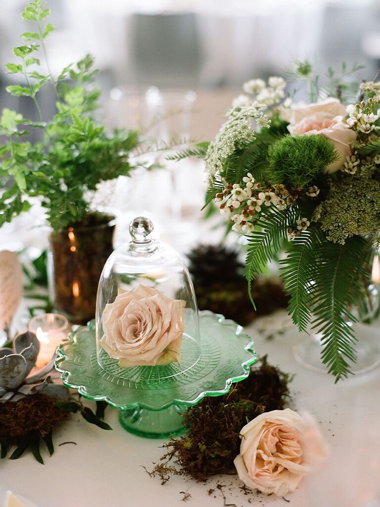 Rose terrarium centerpiece at fairytale-themed wedding