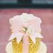 Courtney and Joe’s four-tier wedding cake was decorated with a pink fondant bow and gold ombre polka dots to match the romantic wedding theme.