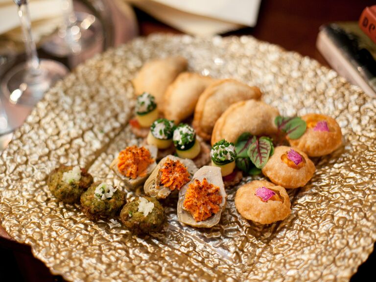 Plate of vegetarian Indian wedding snacks.
