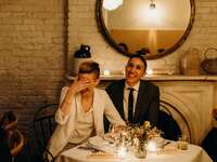 Couple laughing during wedding speeches.