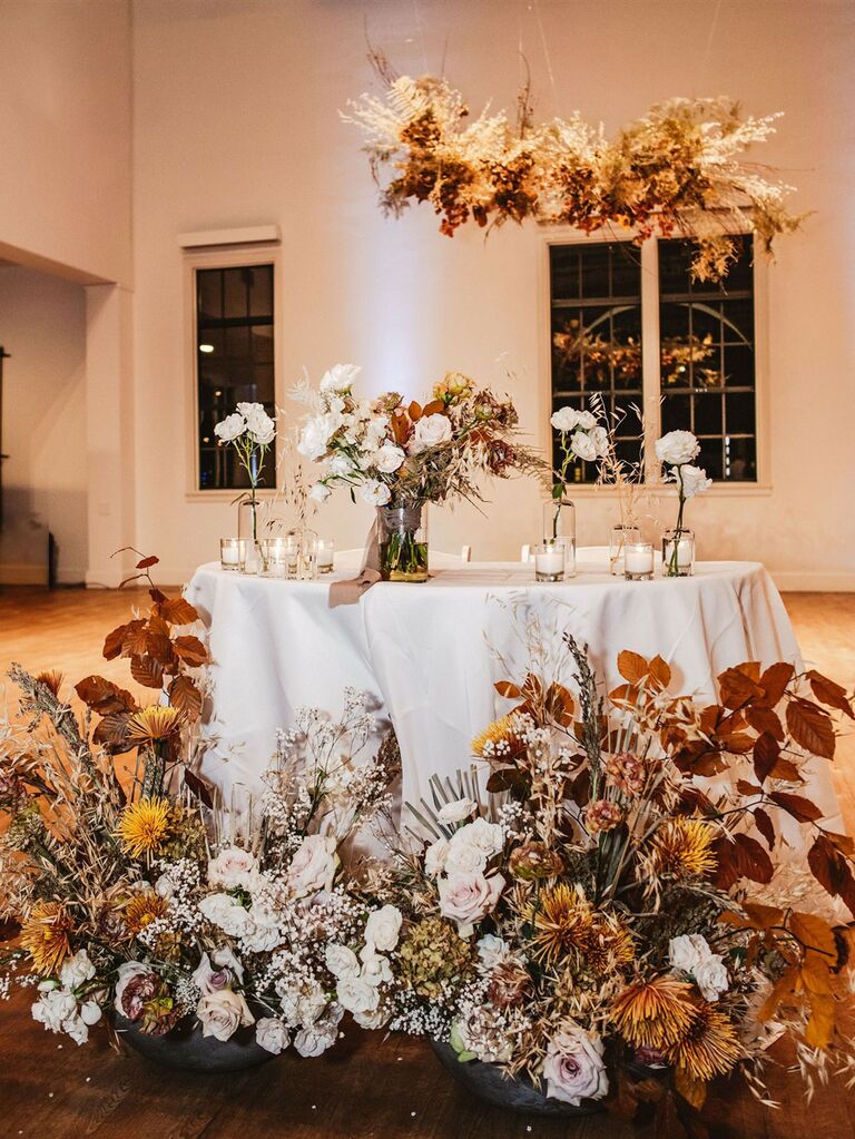 Boho sweetheart table with muted rustic wedding flowers