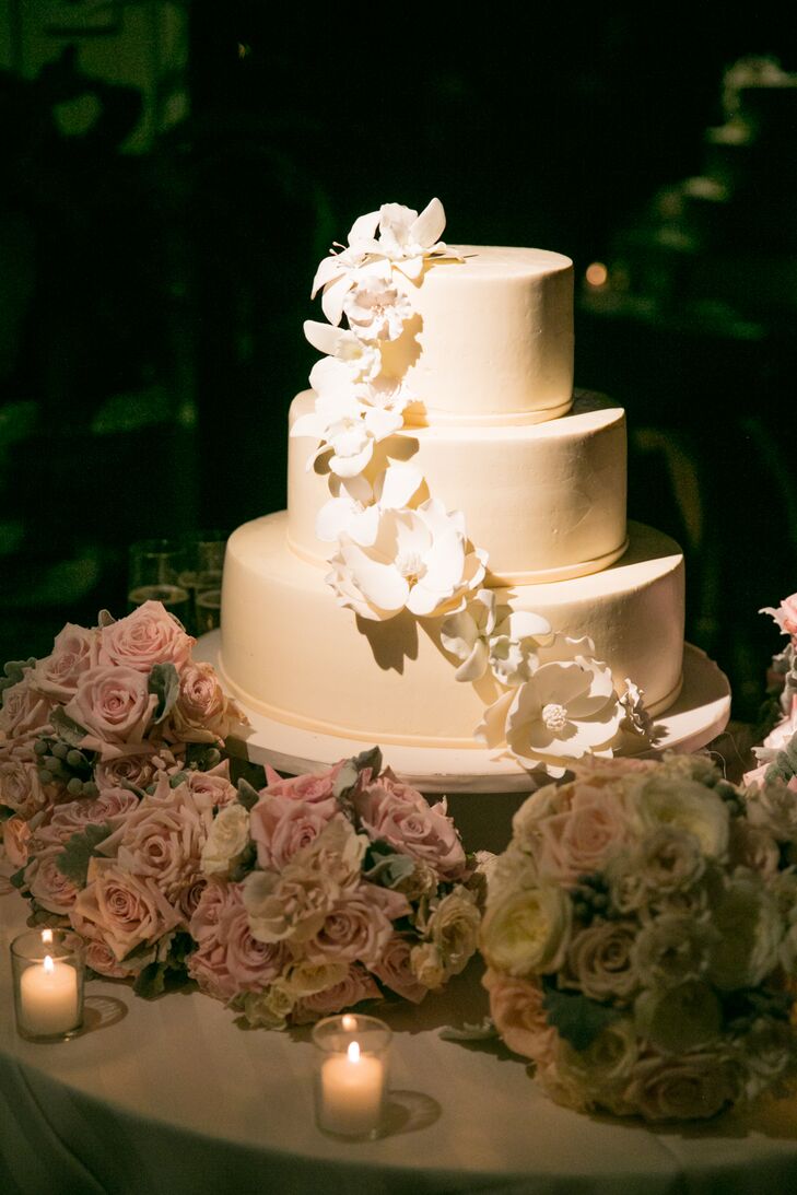 Sweet sugar flowers topped the couple's three-tier fondant wedding cake.