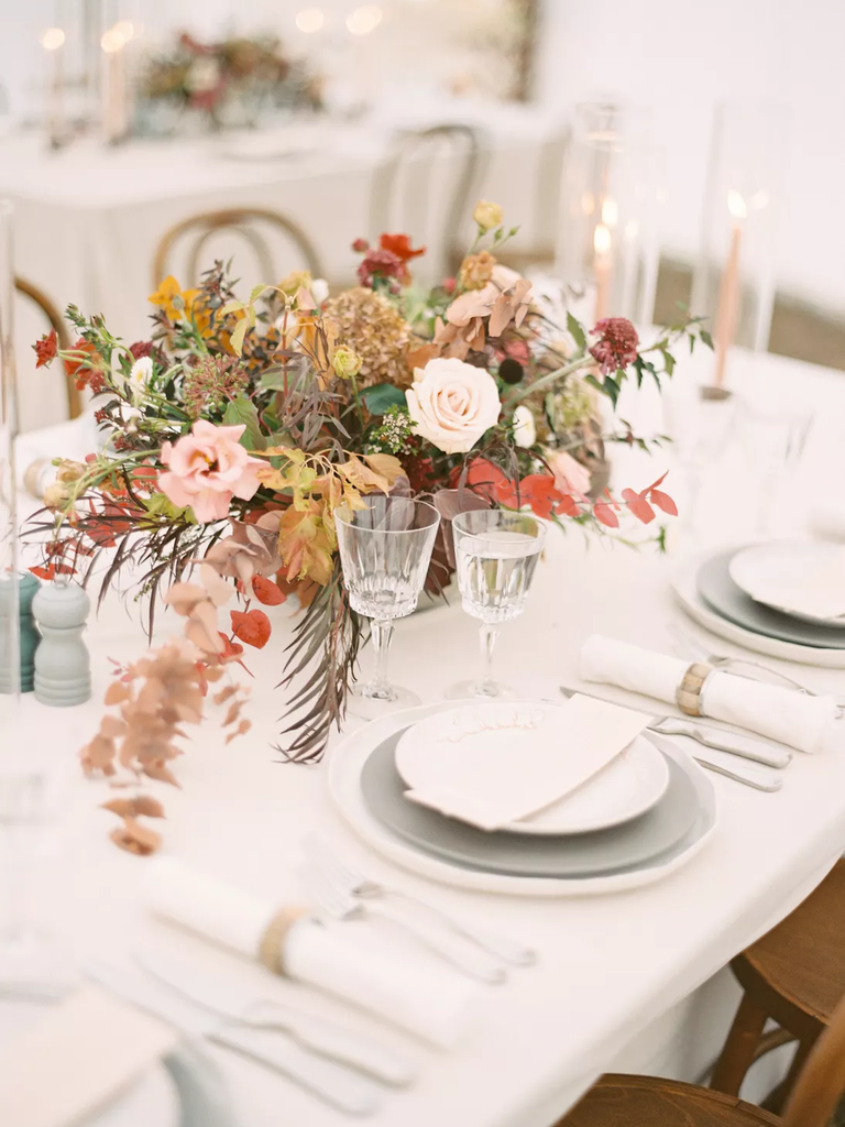 An elegant floral arrangement of eucalyptus, roses, and wildflowers.