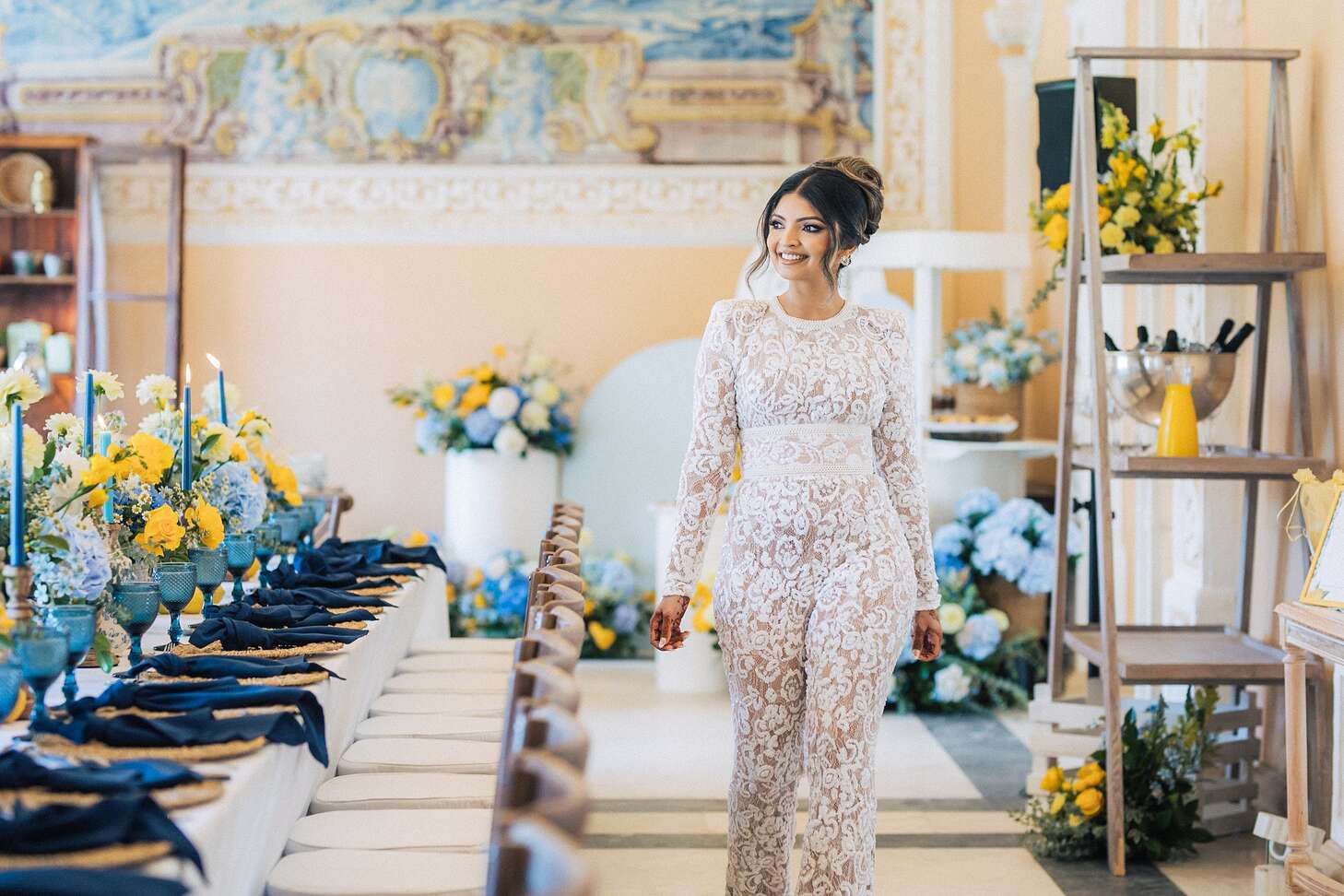 Bride in White Lace Jumpsuit Walks Around Luxurious Blue-and-Yellow Bridal  Shower