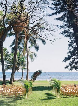 Lawn Ceremony Space on Maui Beach With Circular Arch With Greenery in Vases on Aisle