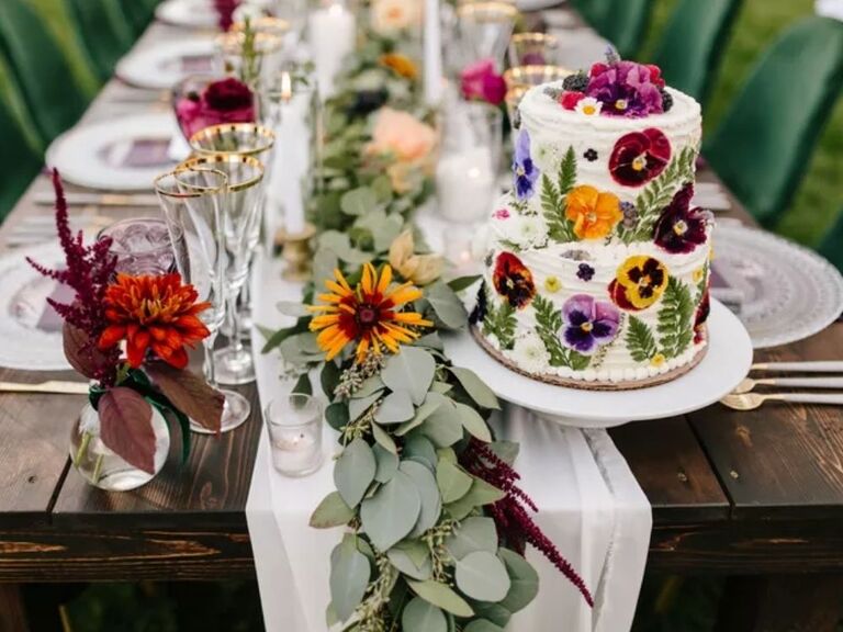 Farm table with rustic cake decorated with pansy blooms