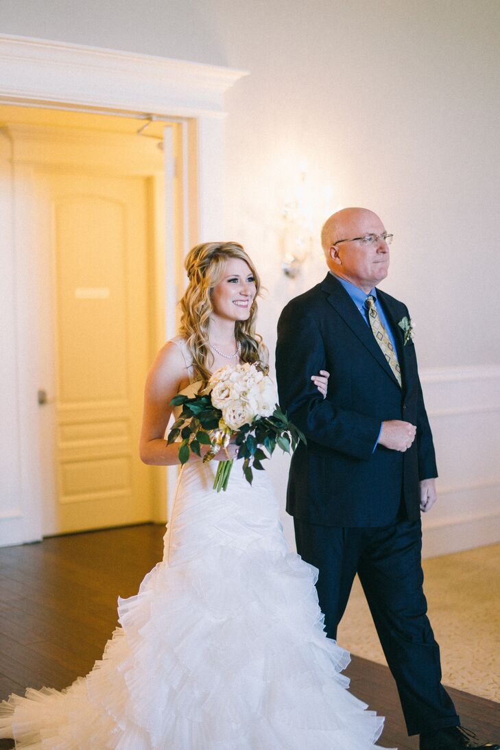 Elena and her father walked arm in arm down the aisle. She clutched a DIY bouquet of faux ivory roses and eucalyptus leaves.