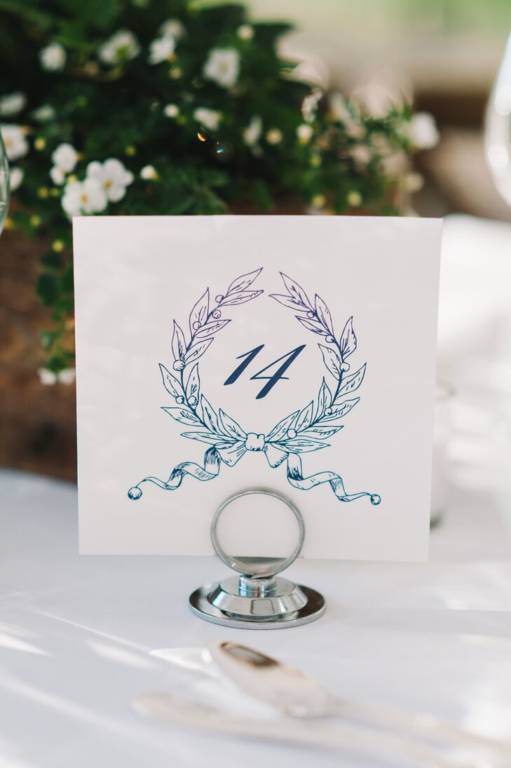 Anna drew a custom wreath logo that was then incorporated throughout the couple's entire invitation suite – including these elegant table numbers.