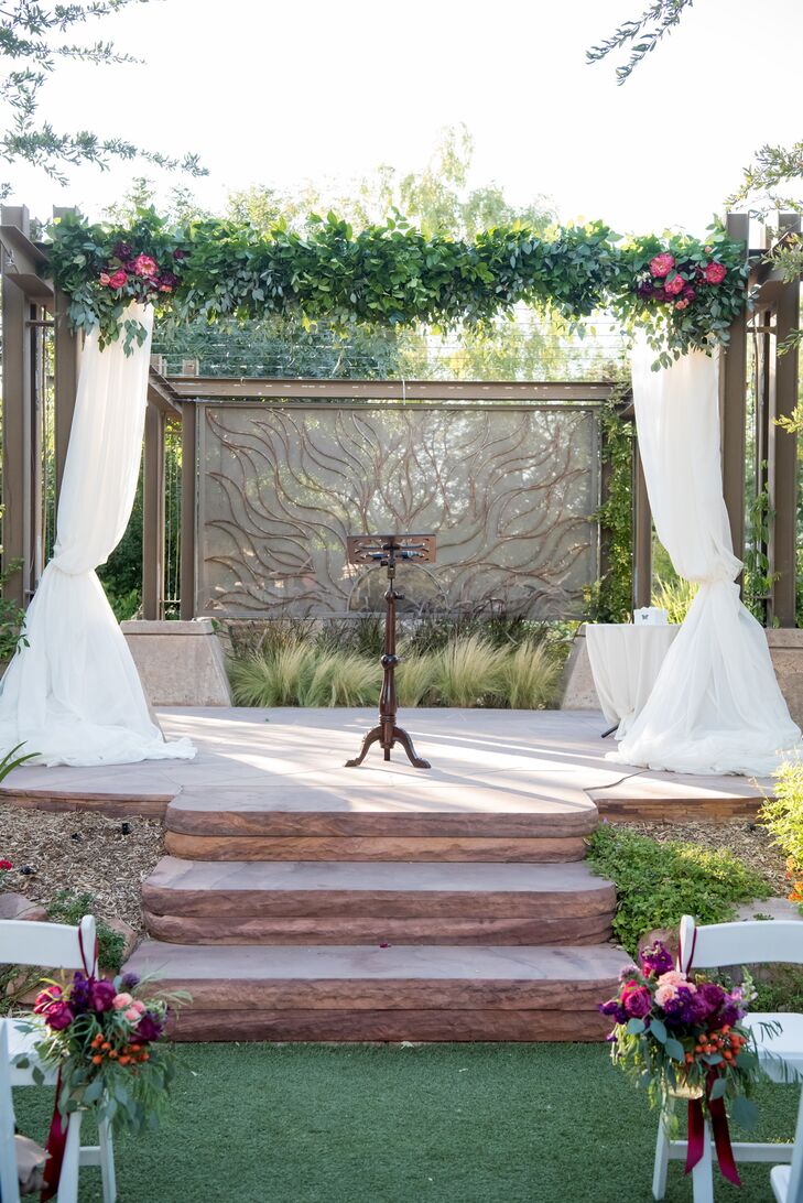 "We knew the Springs Preserve was the place our wedding needed to be the moment we walked in," Jenna says. "It had the botanical garden feel we wanted, and we knew the weather would be perfect in October." The ceremony took place at the arboretum under a greenery-rich arch.